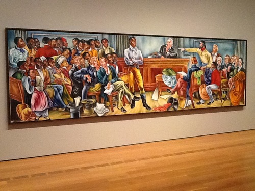 One of six murals by Hale Woodruff in a series called Rising Up, depicting the trial that followed the uprising on the Amistad and commissioned in 1938 to commemorate the 1867 founding of Talladega College and “celebrate its success as one of the nation’s first all-black colleges.” The murals portray “heroic efforts to resist slavery as well as moments in the history of the college, which opened in 1867 to serve the educational needs of a new population of freed slaves.”